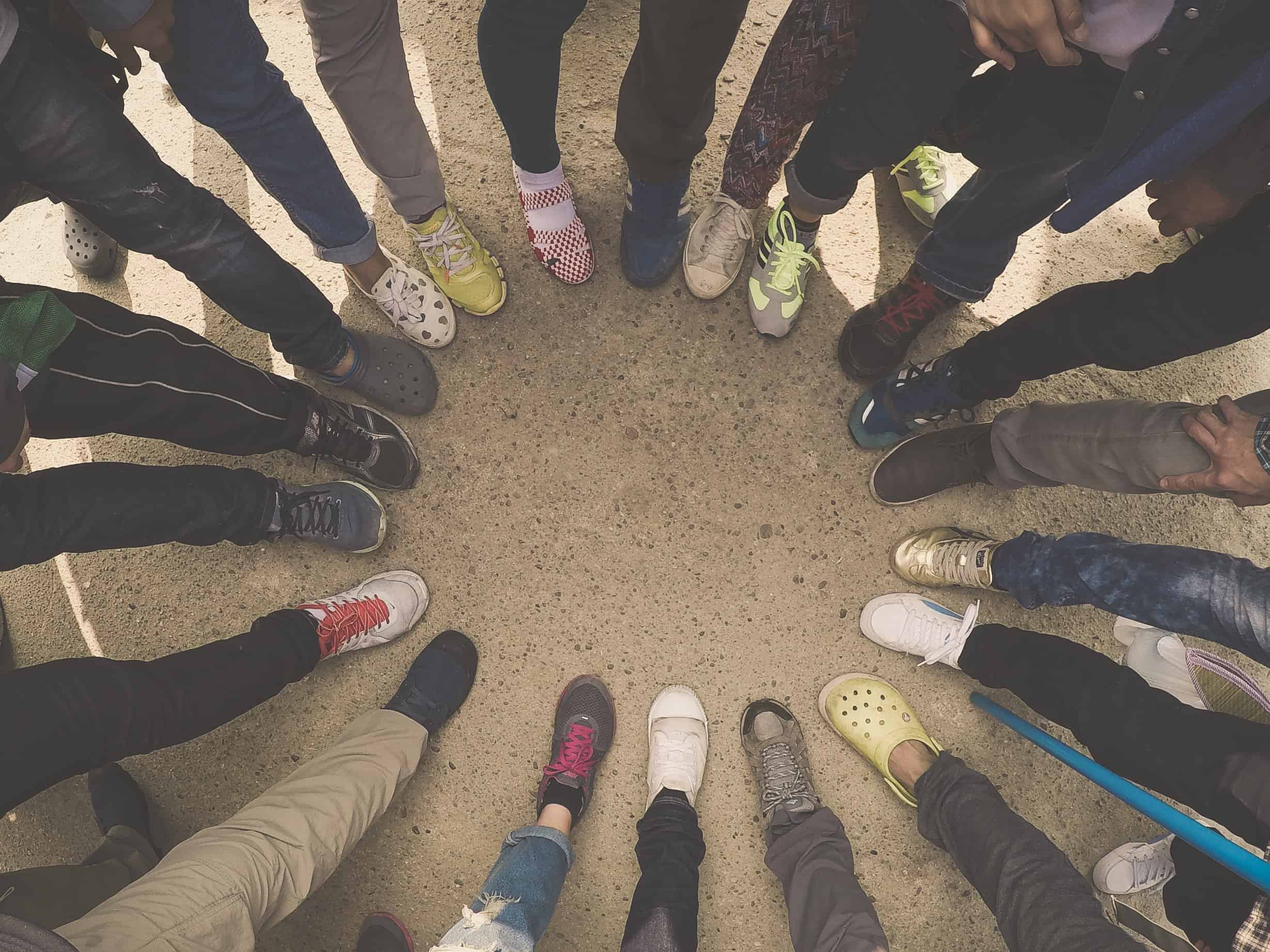 Circle of people with one foot forward